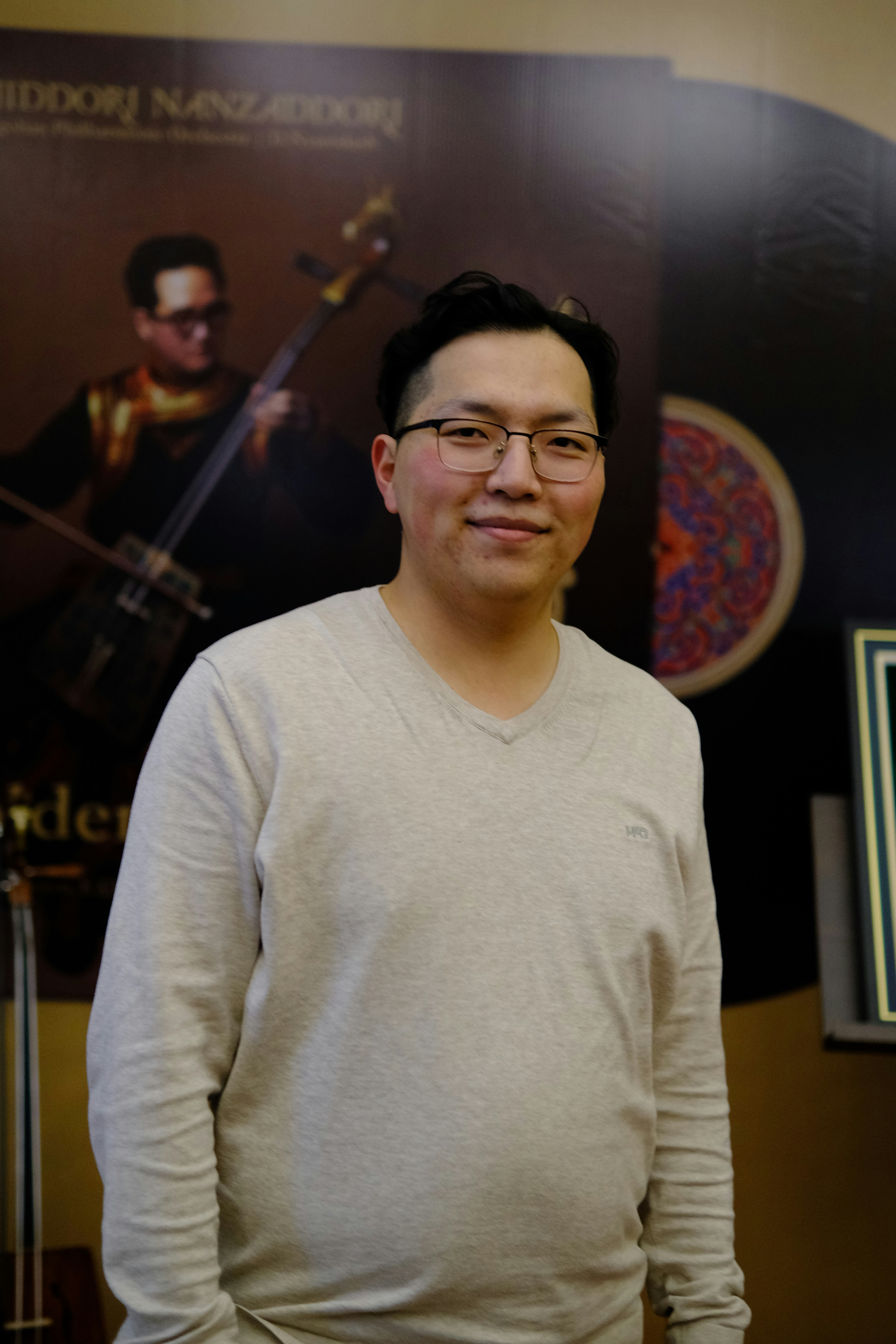 A man standing in front of a movie poster