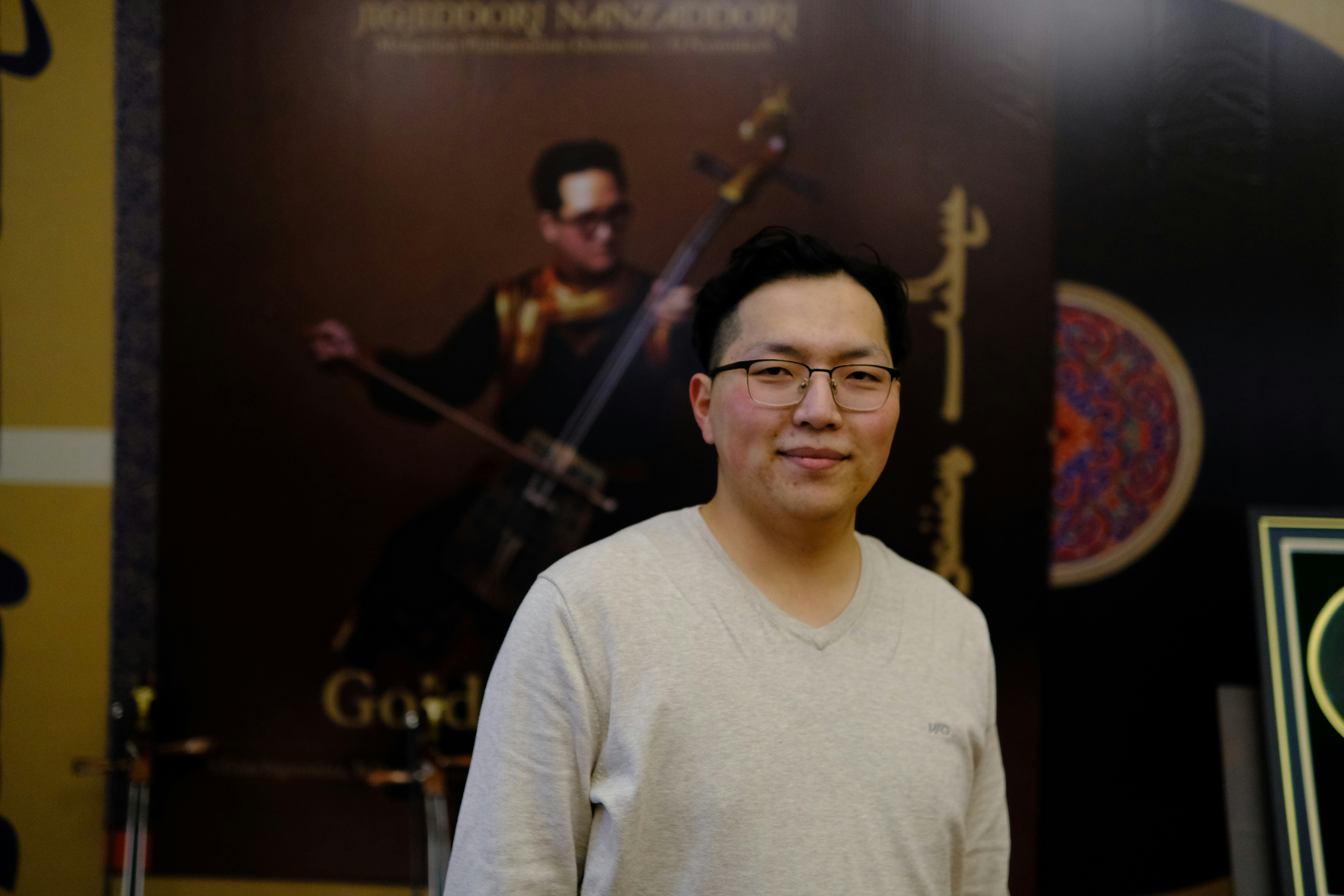 A man standing in front of a movie poster