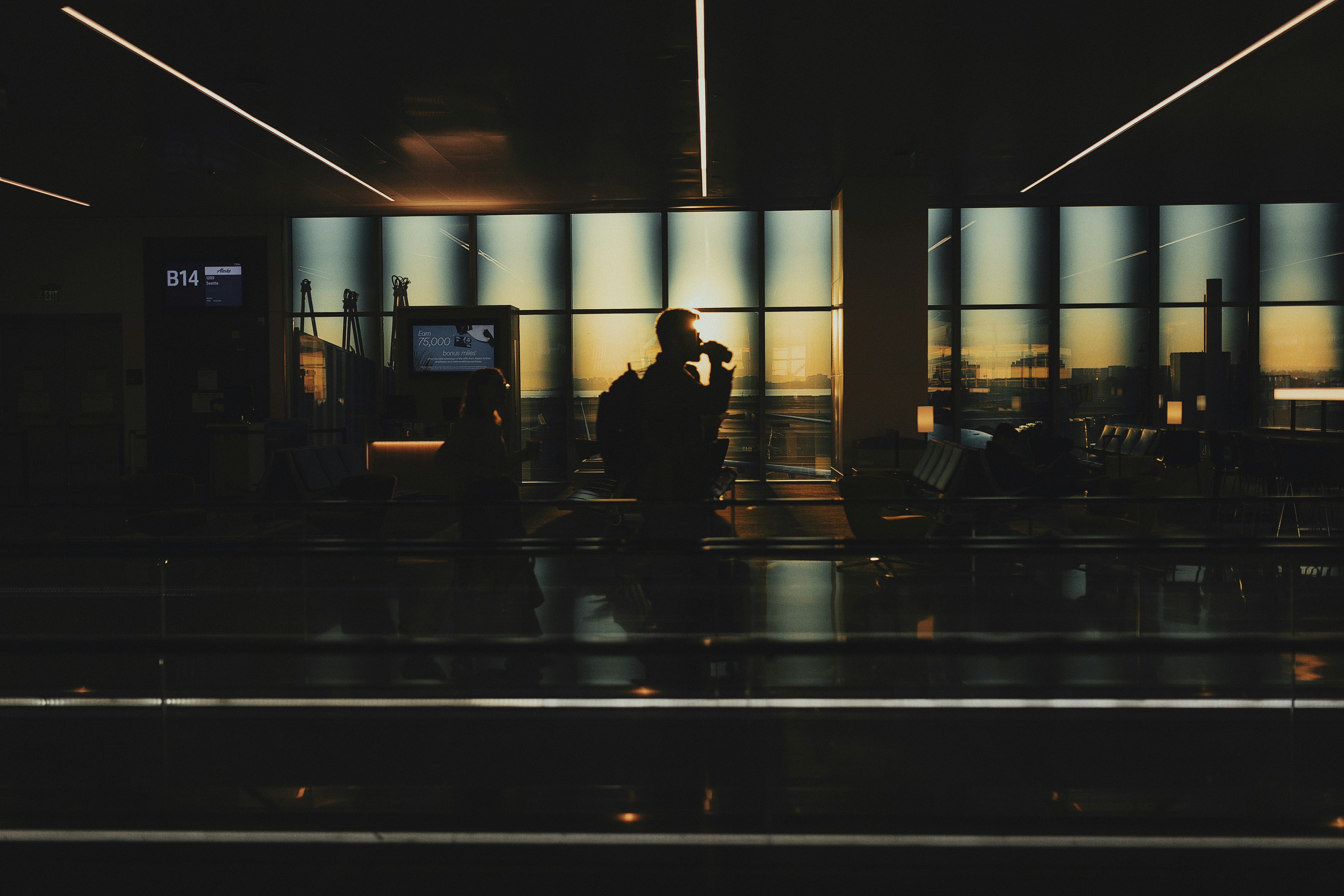 A man standing in front of a window at night, 