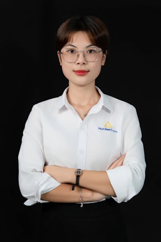 A woman wearing glasses and a white shirt