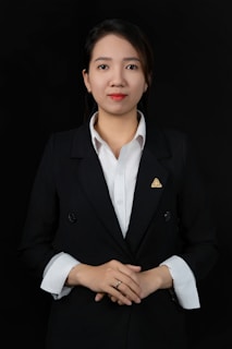 A woman wearing a black suit and white shirt