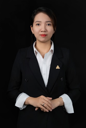 A woman wearing a black suit and white shirt