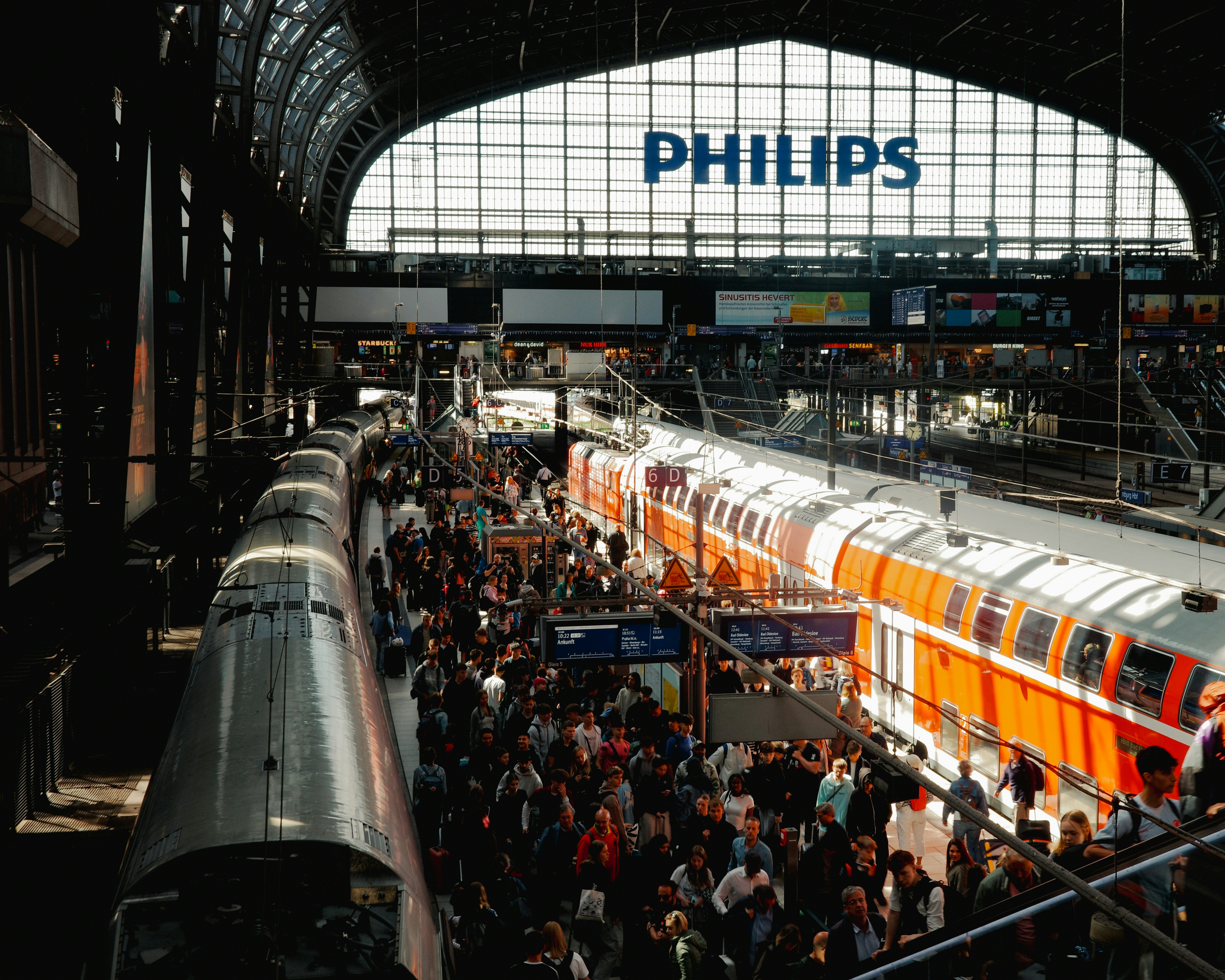 A group of people standing next to a train at a train station