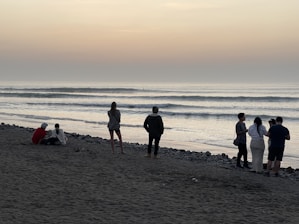 A group of people standing on top of a beach