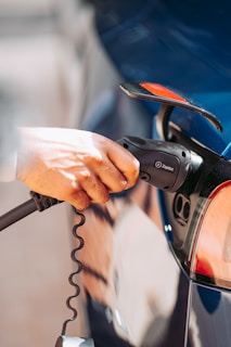 A person is pumping gas into a car