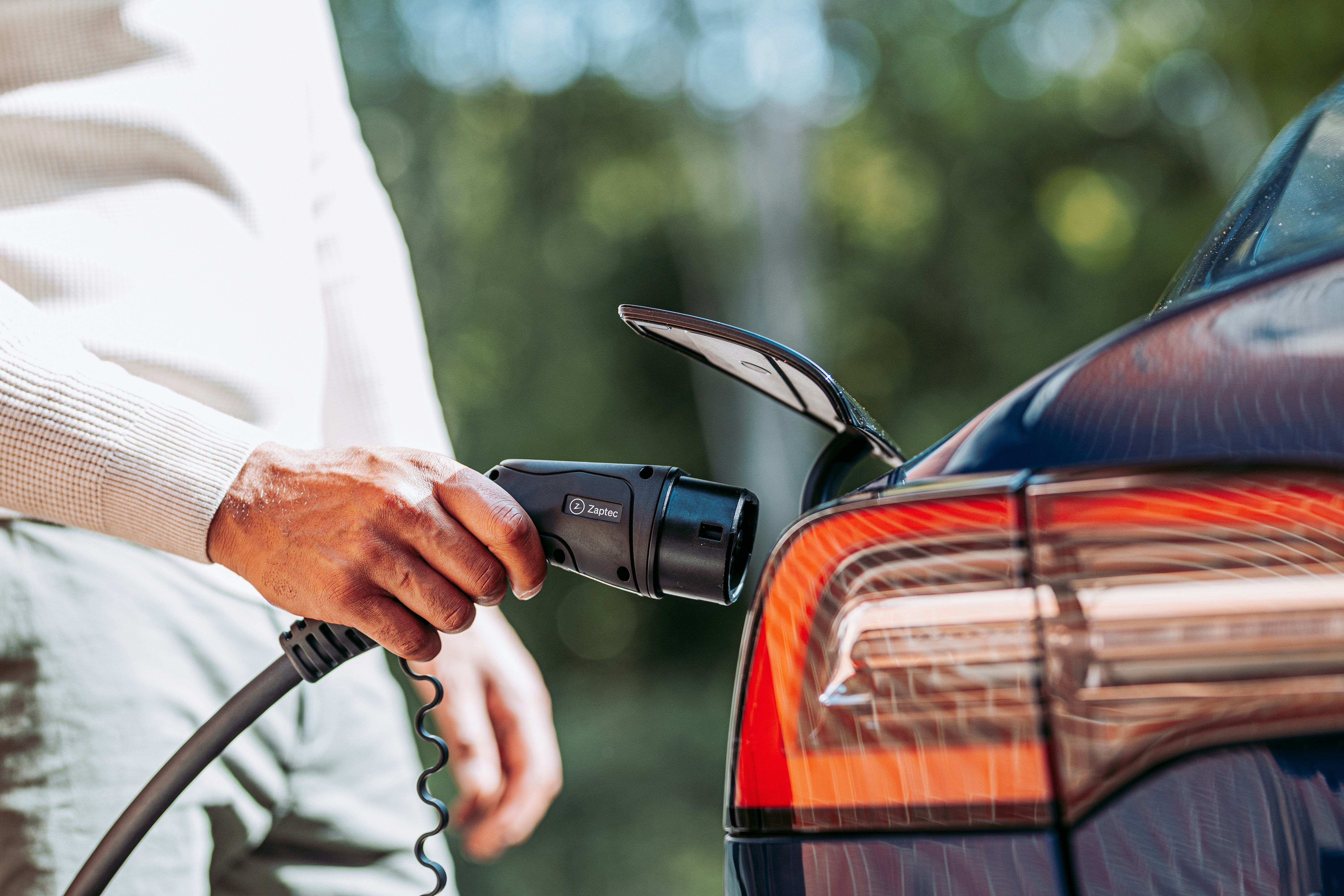 A man pumping gas into his car at a gas station