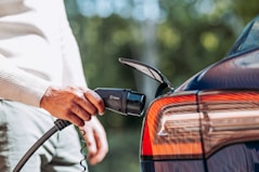A man pumping gas into his car at a gas station