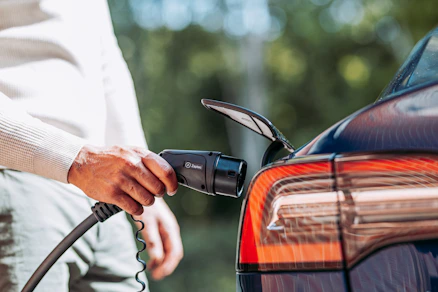 A man pumping gas into his car at a gas station