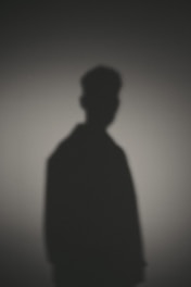 A shadow of a man standing in the dark