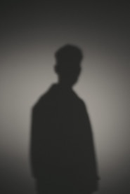 A shadow of a man standing in the dark