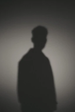 A shadow of a man standing in the dark