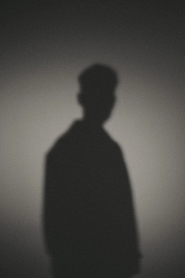 A shadow of a man standing in the dark