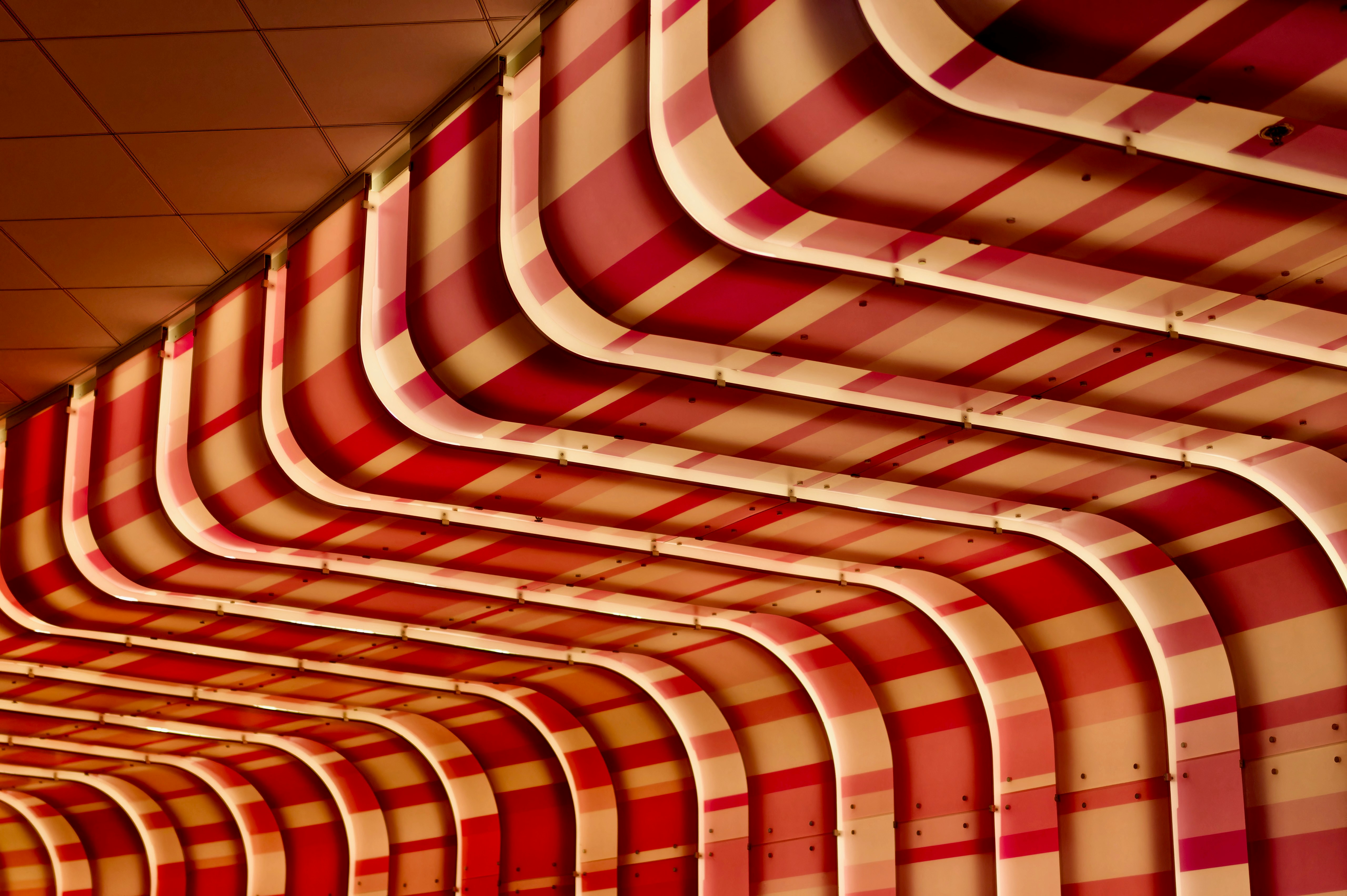 A row of red and white striped chairs in a room
