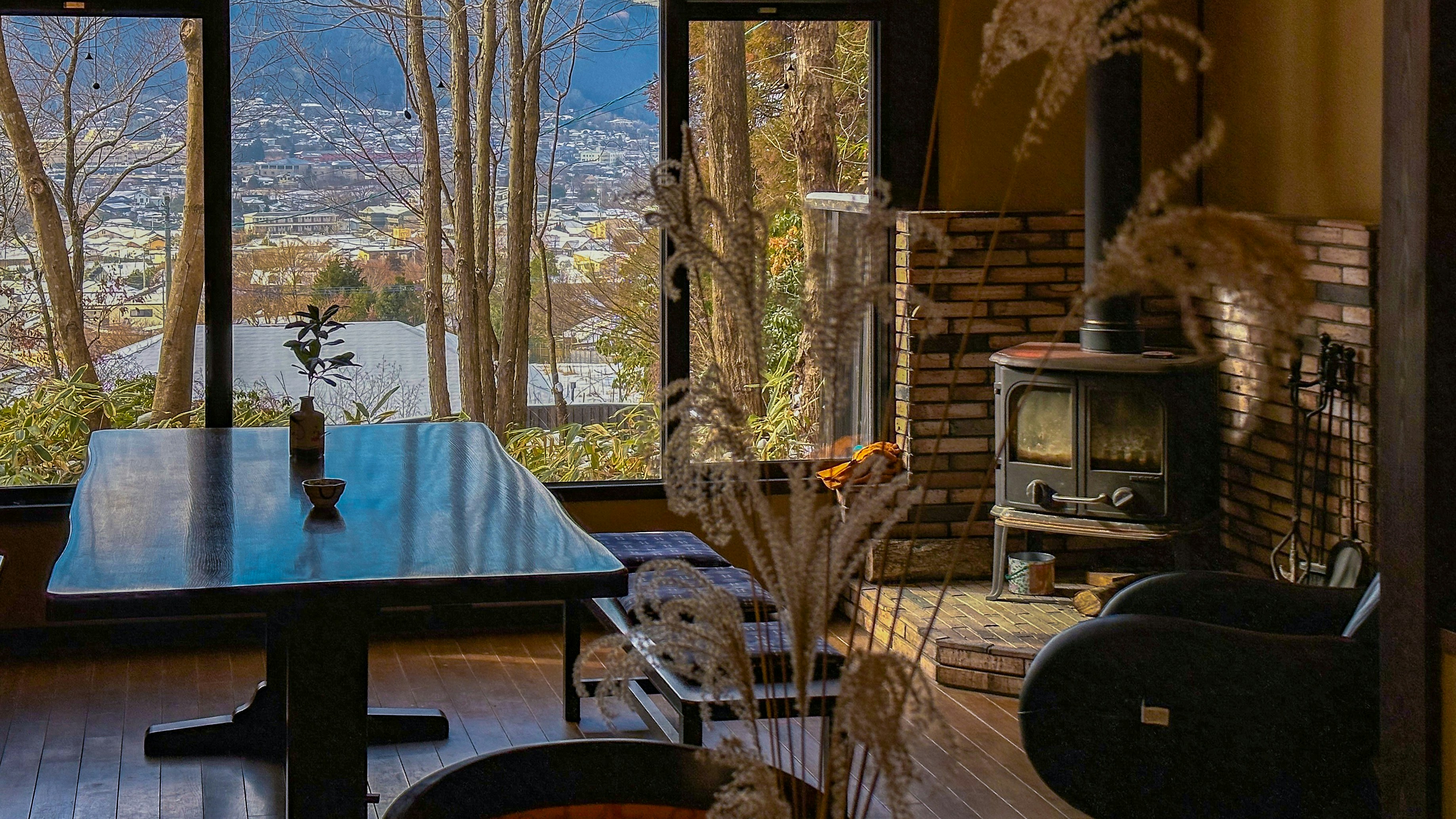 A living room with a table and a view of the mountains
