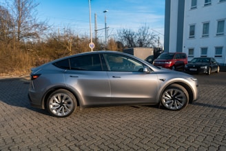 A silver car parked in front of a building