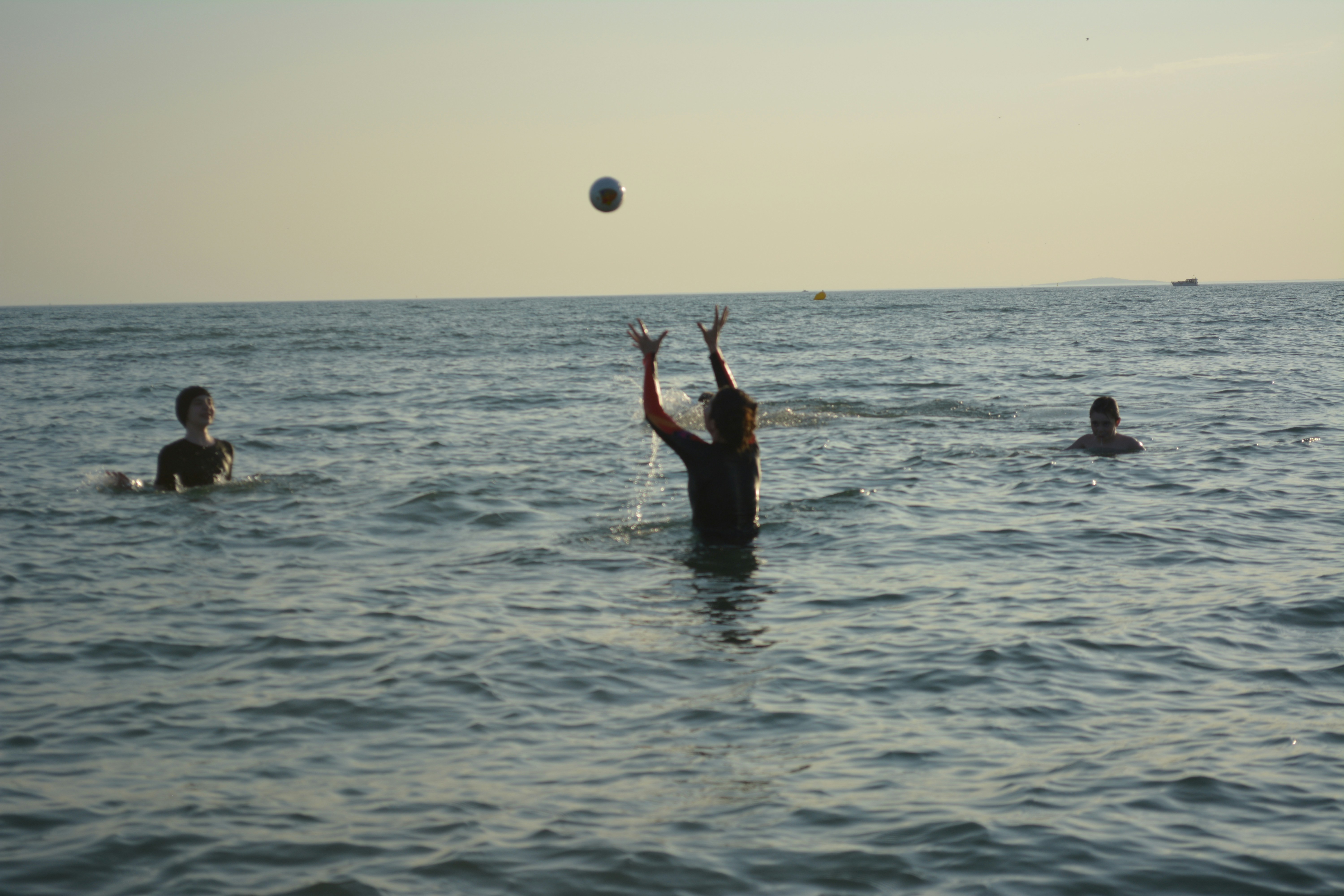 A group of people in the water playing with a ball
