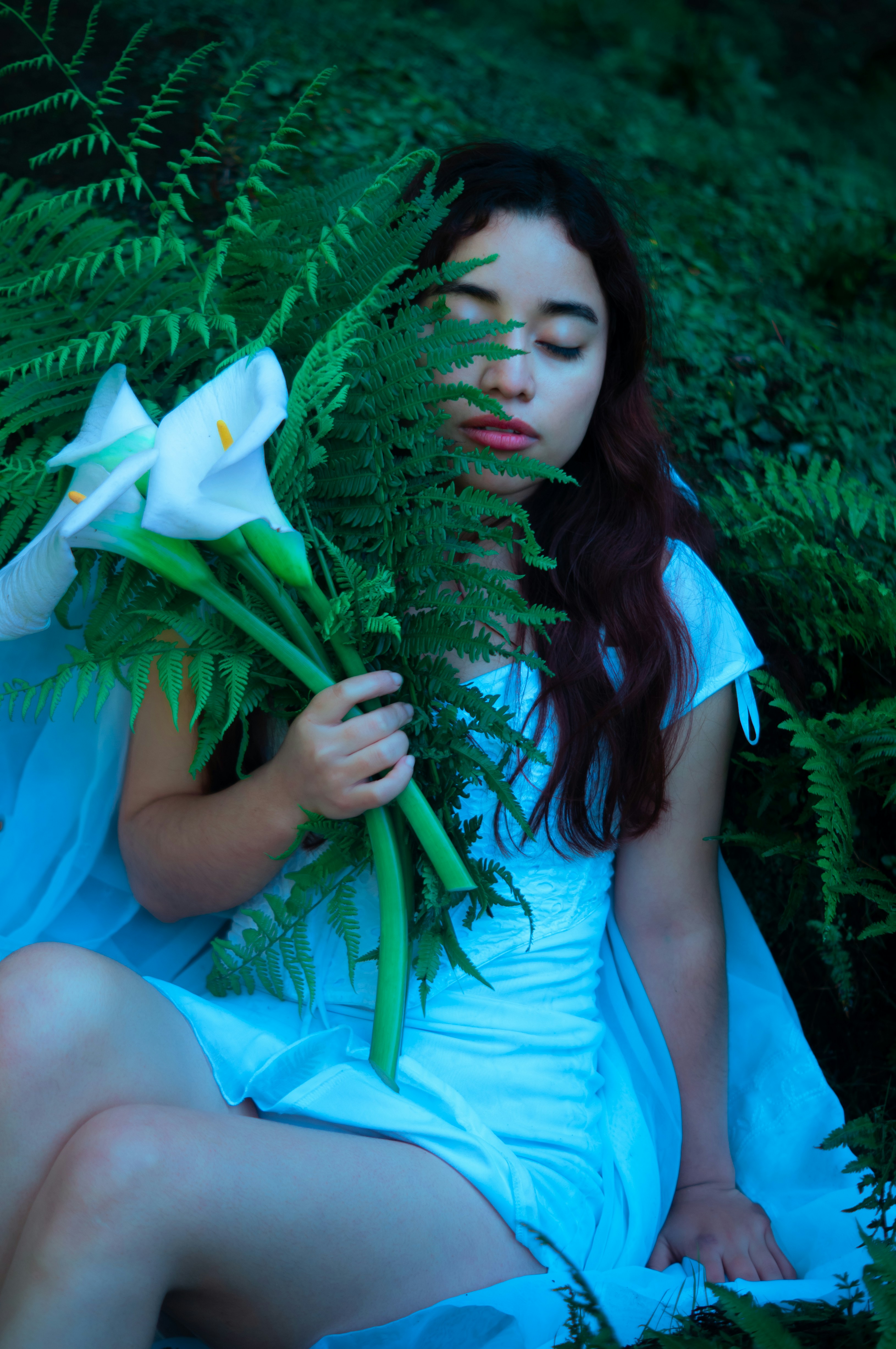 Fotomural A woman is sitting in the grass with flowers