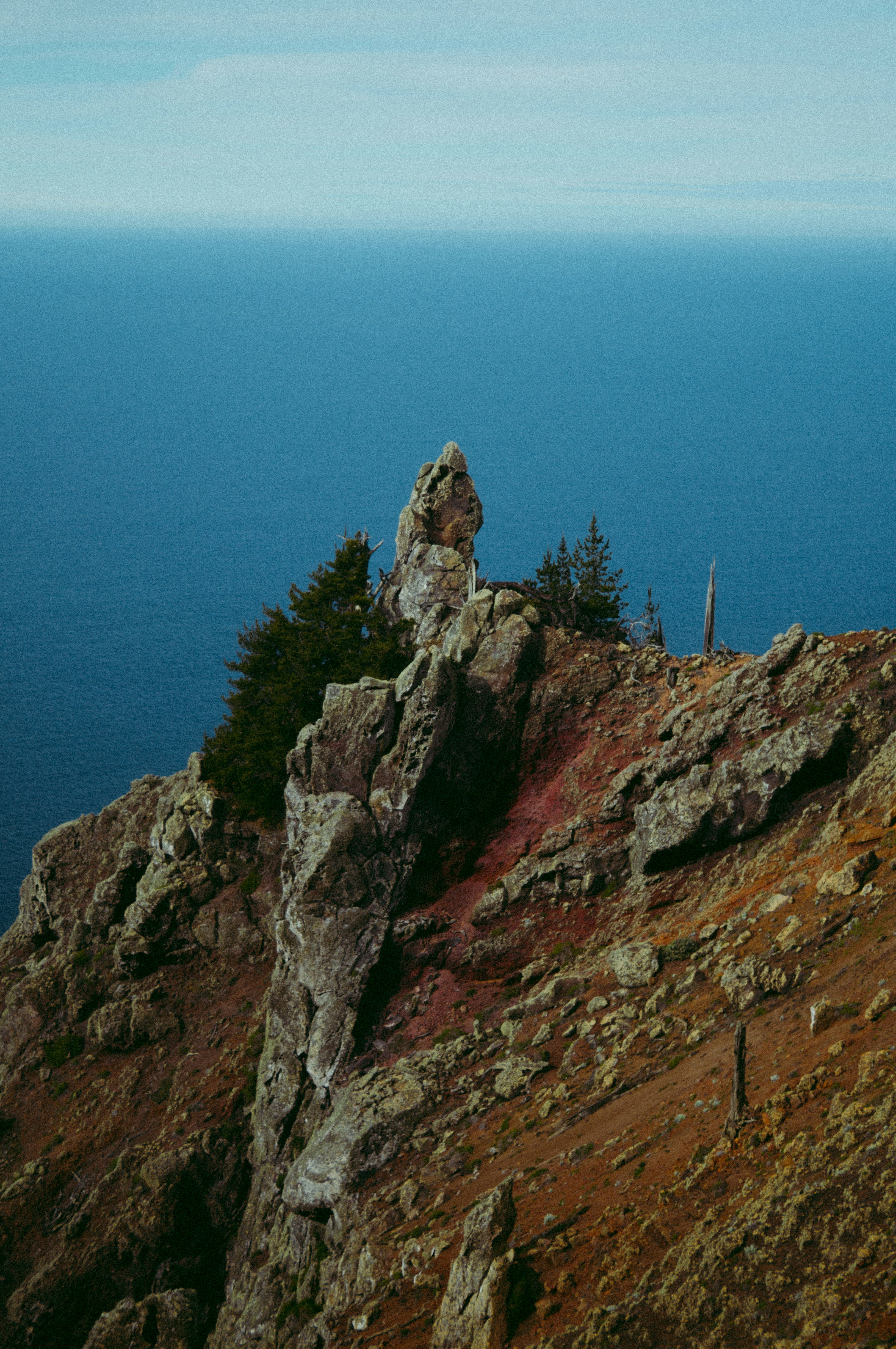 A person standing on top of a rocky mountain