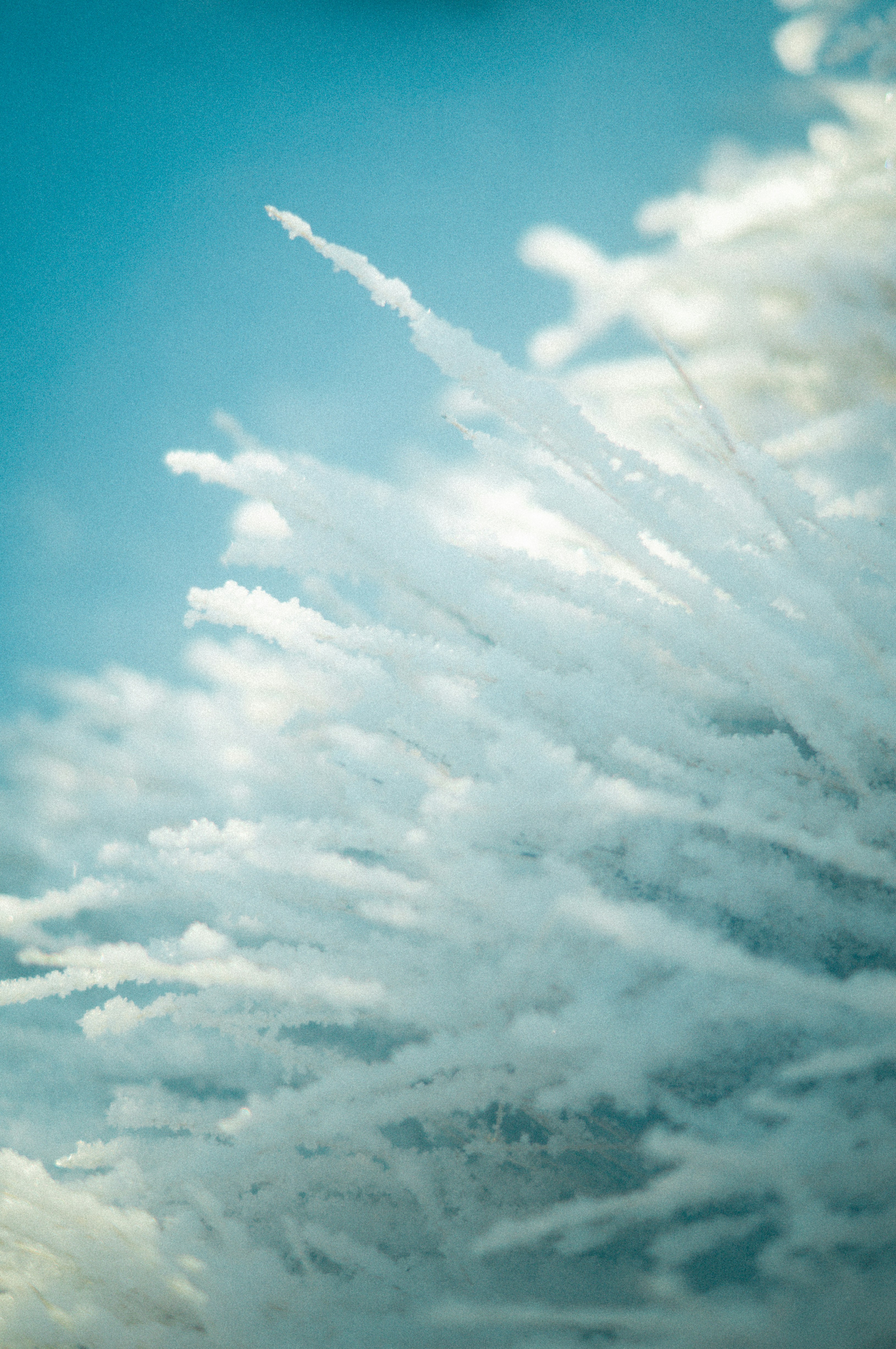 A plane flying in the sky with a lot of clouds