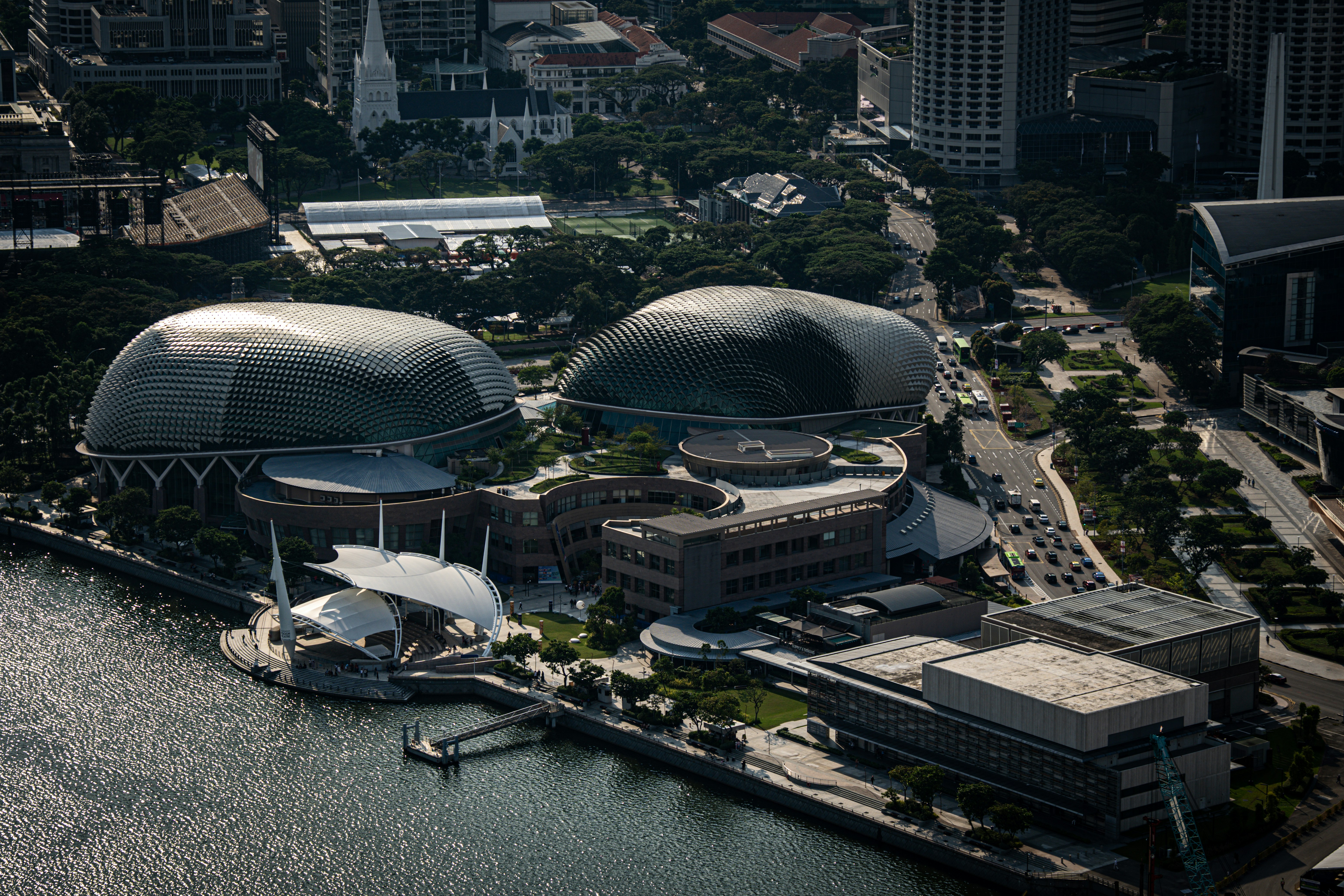An aerial view of a city with buildings and a body of water