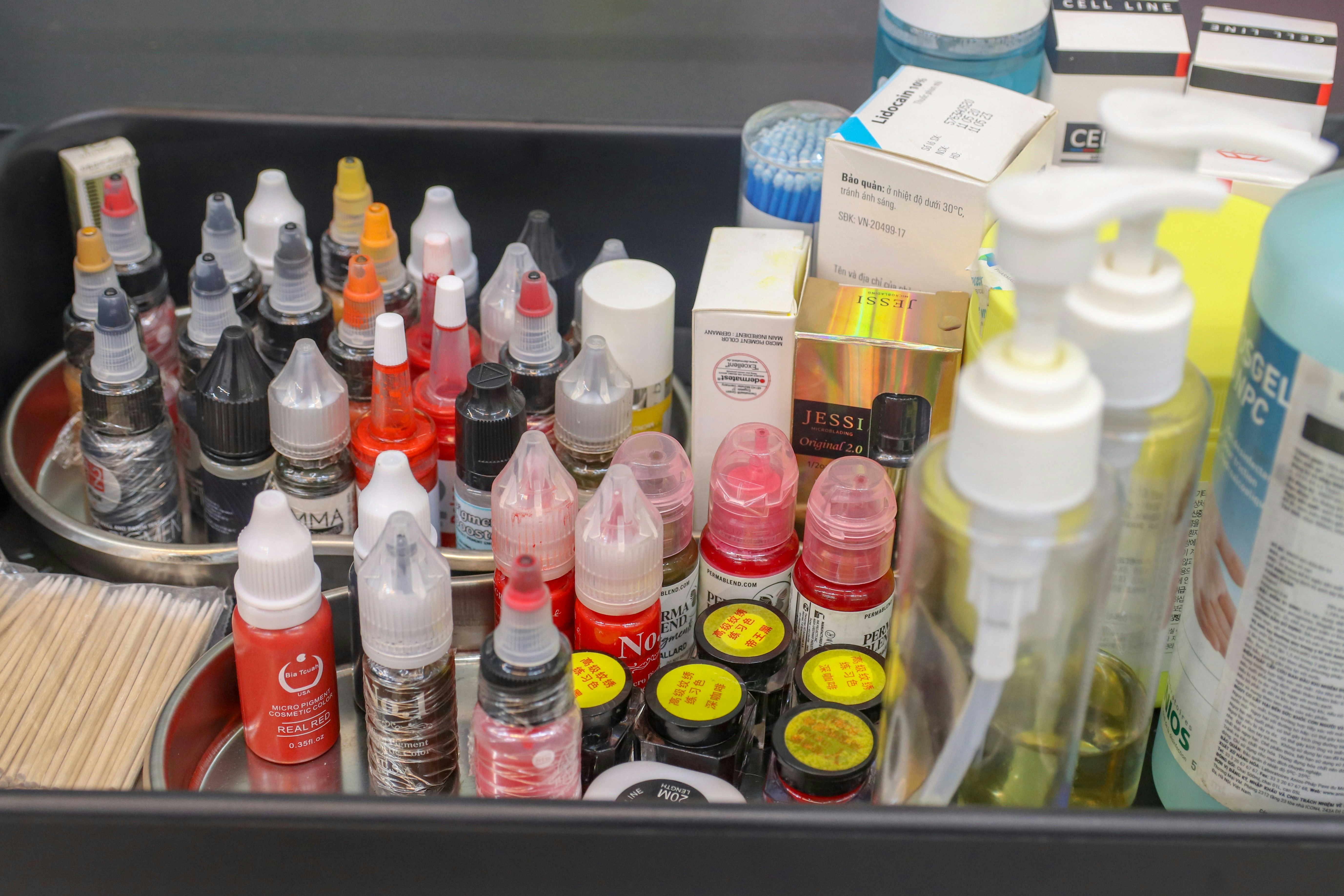 A metal container filled with lots of different types of paint photo ...
