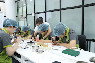 A group of people working on something on a table
