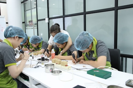 A group of people working on something on a table