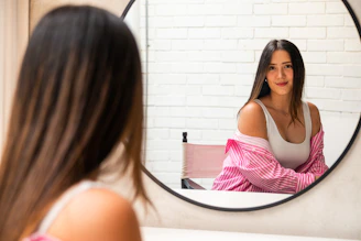 A woman looking at herself in the mirror