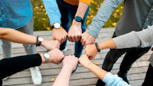 A group of people putting their hands together
