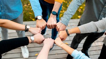 A group of people putting their hands together