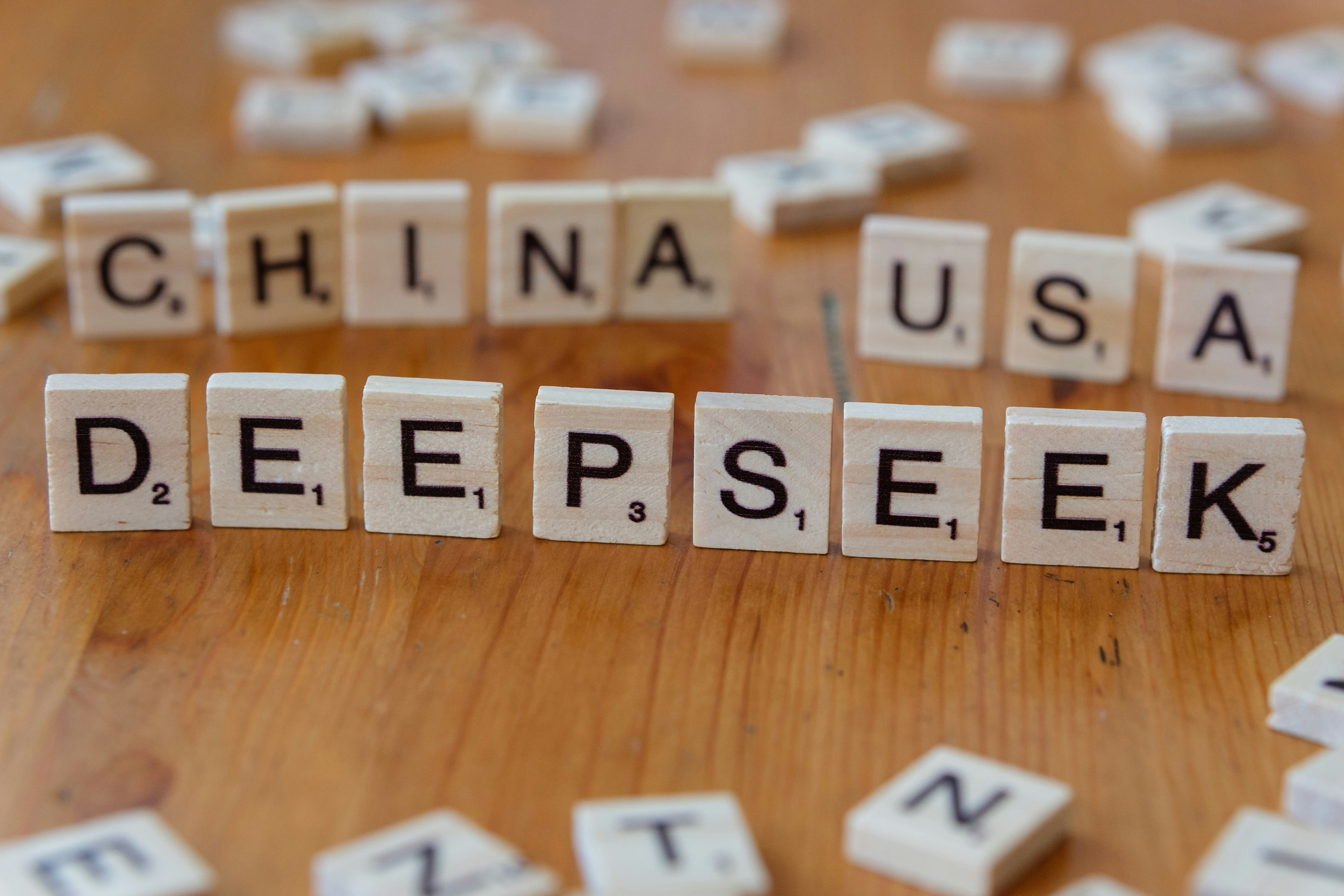 Scrabble tiles spelling the word china, usa, deepseek, and