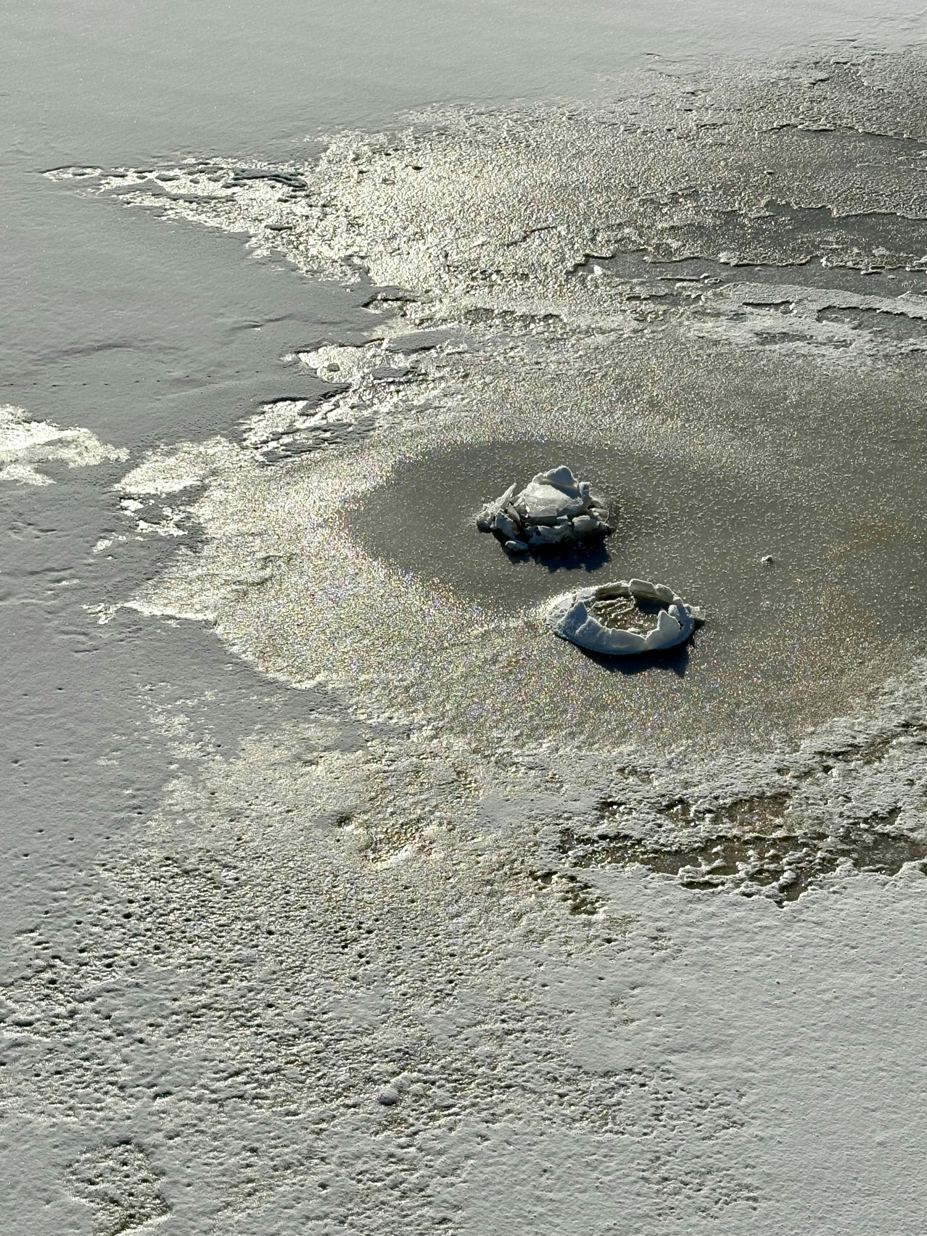 A couple of boats floating on top of a body of water