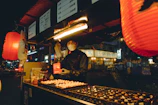 A man standing in front of a counter filled with food