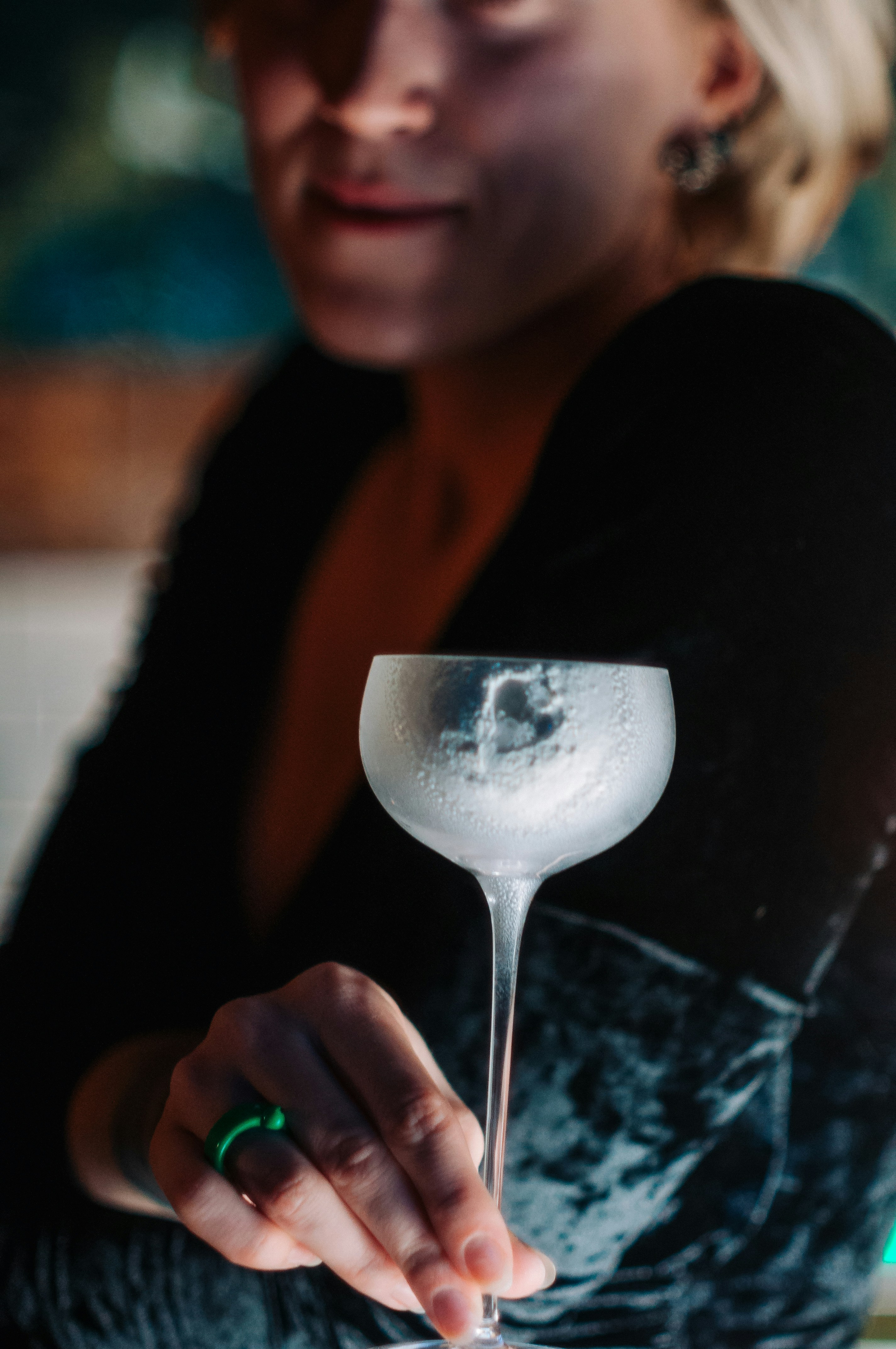 A woman holding a martini glass in her hand