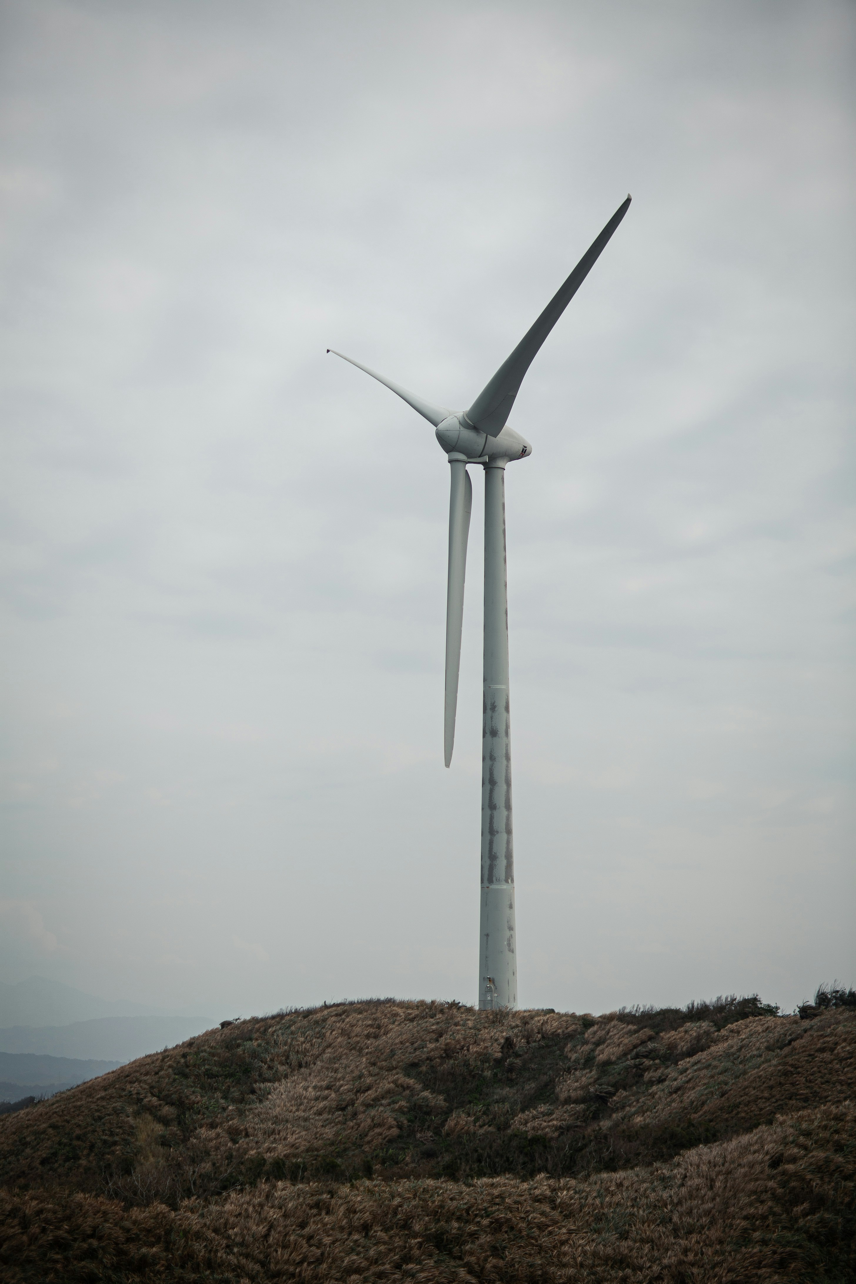 A wind turbine on top of a hill photo – Free Machine Image on Unsplash
