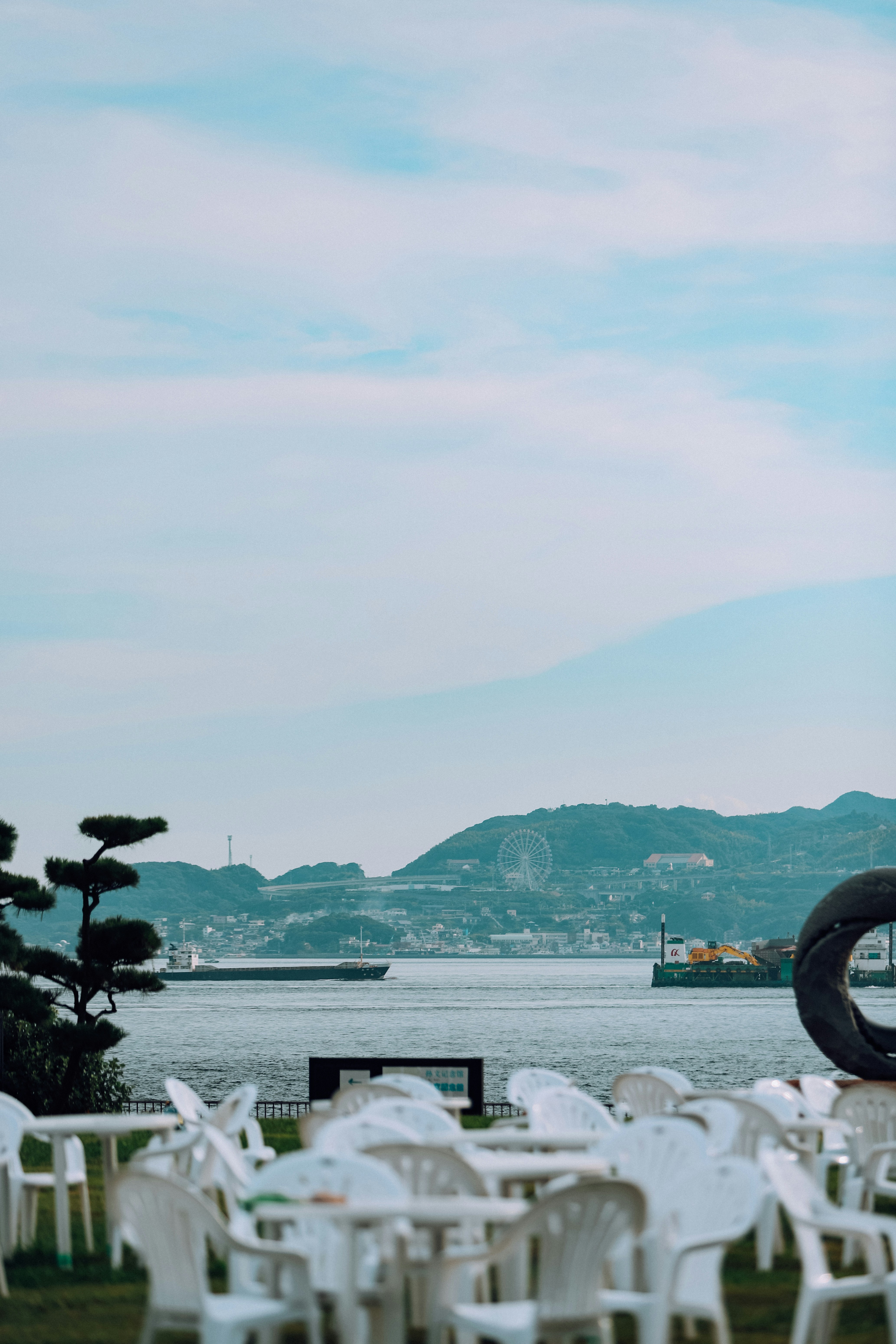 Tables and chairs are set up near the water