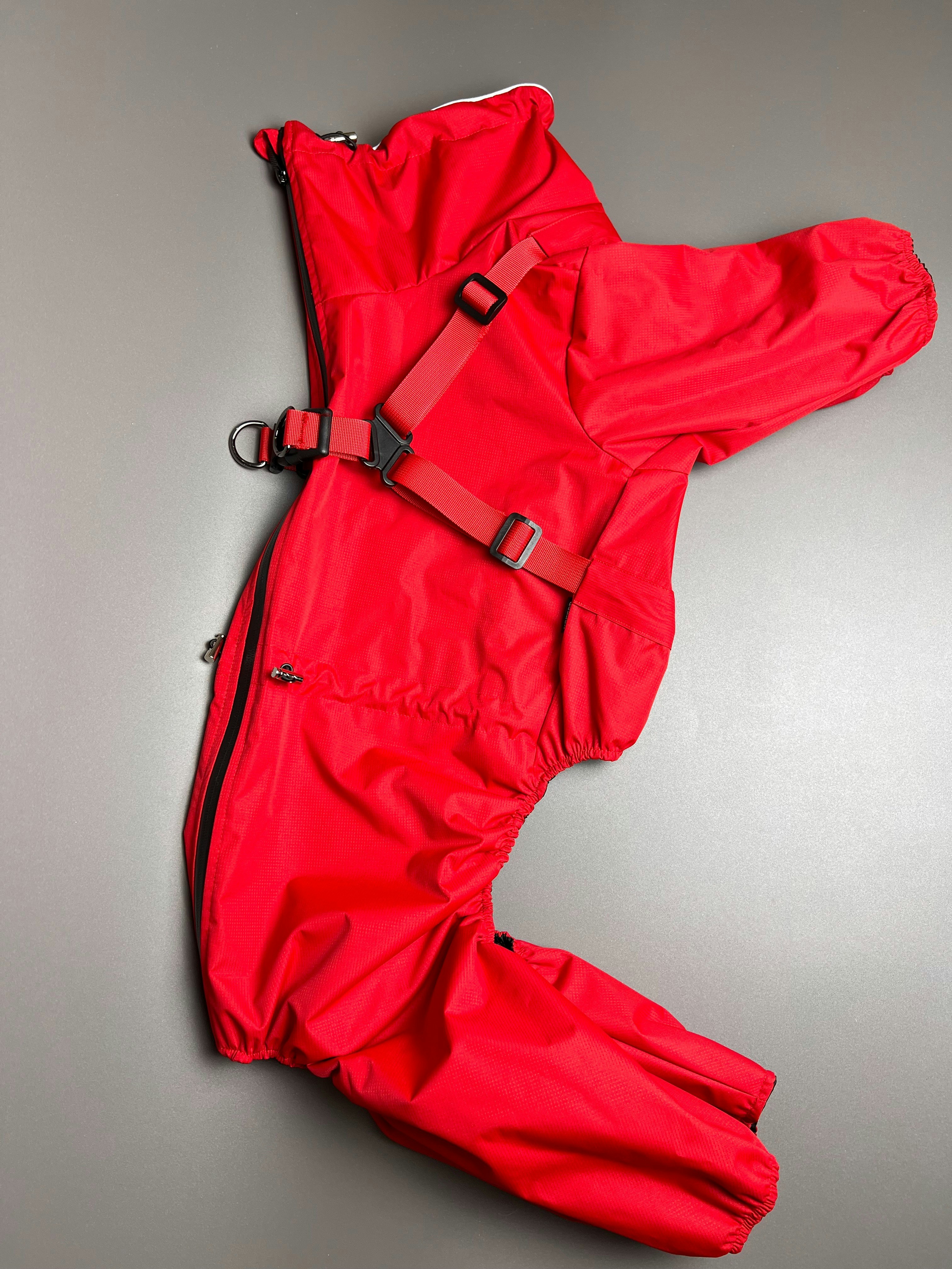 A red jacket laying on top of a table