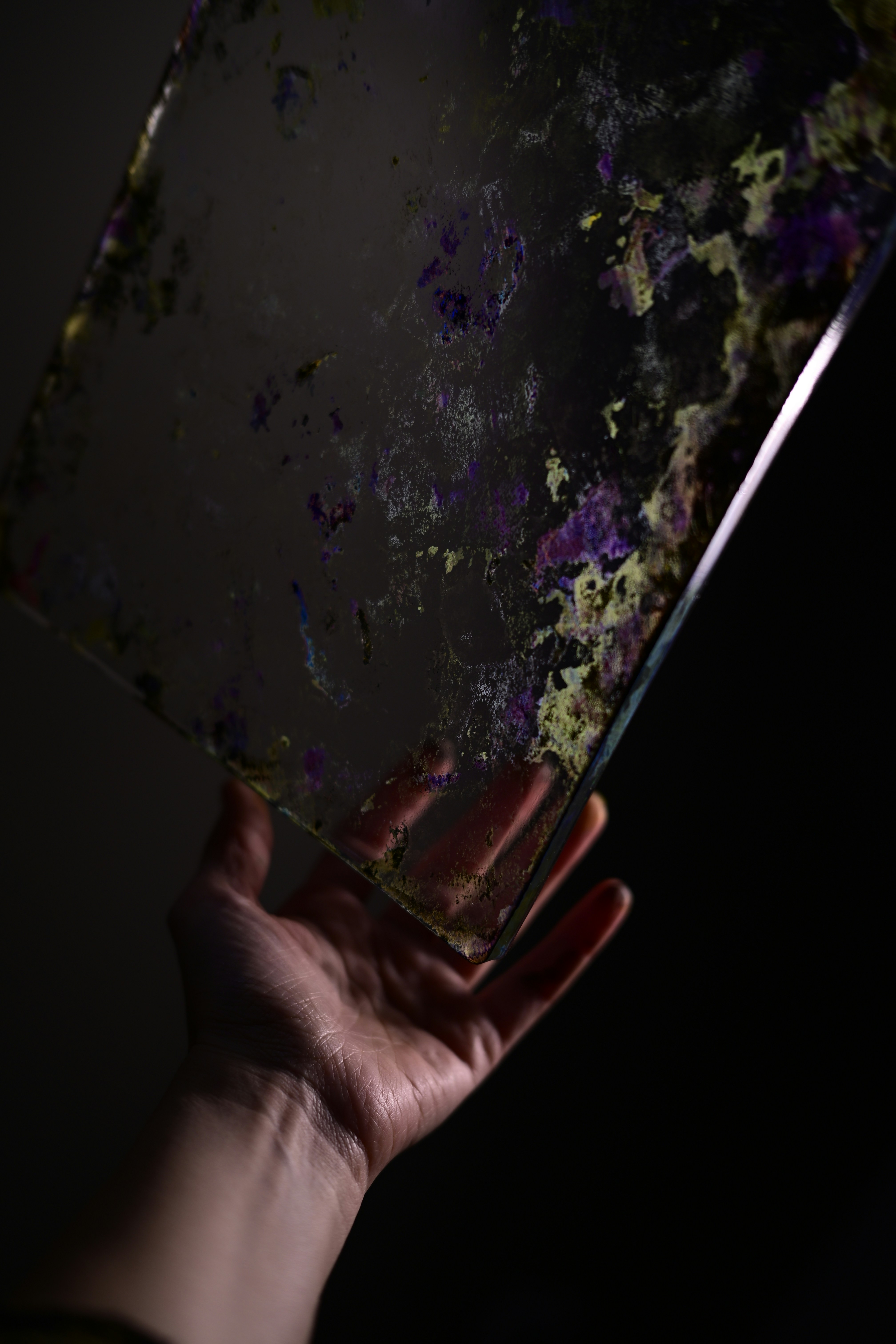 A person holding a piece of glass in their hand