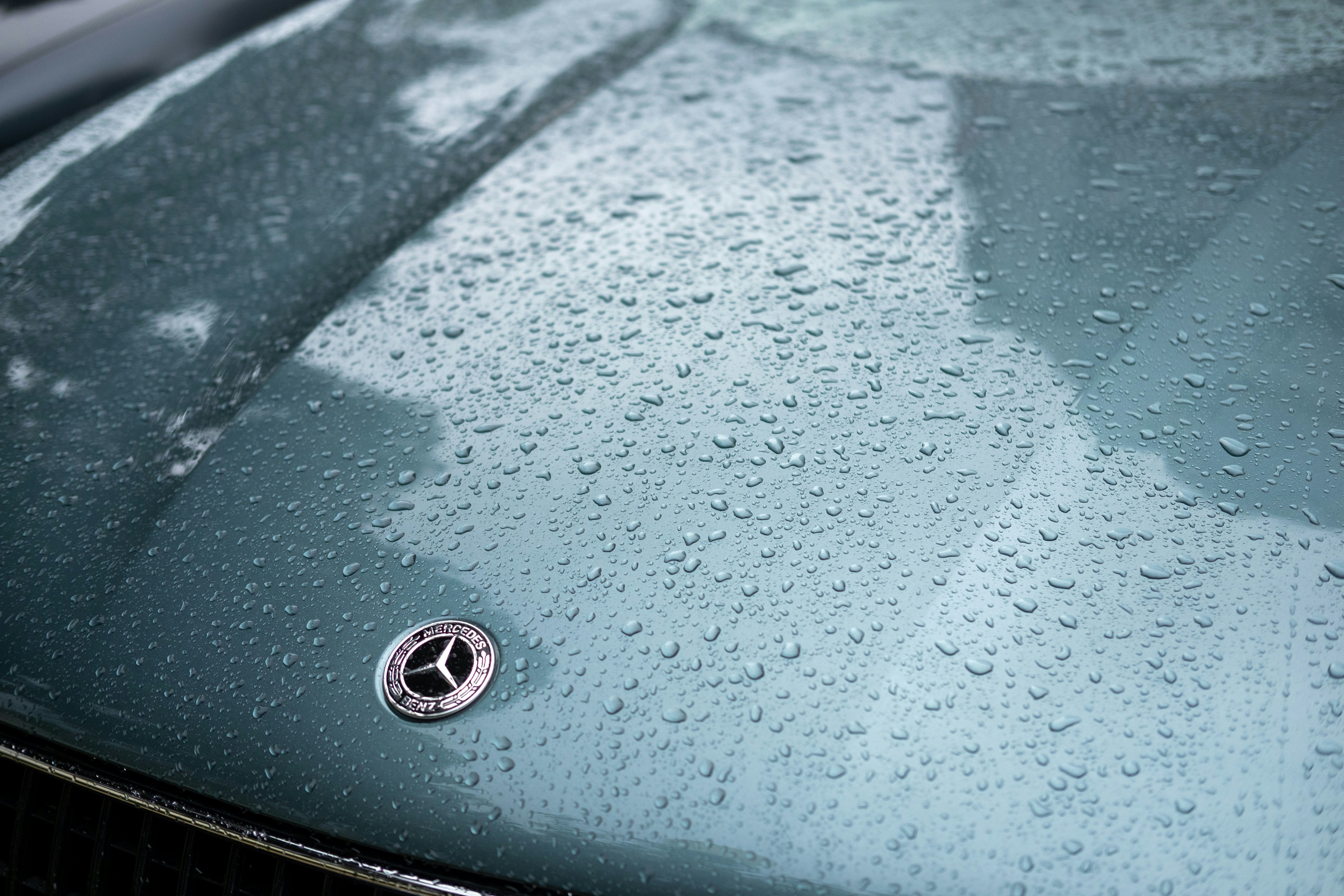 Image of water beading flawlessly on a a ceramic-coated car hood - premium car wash