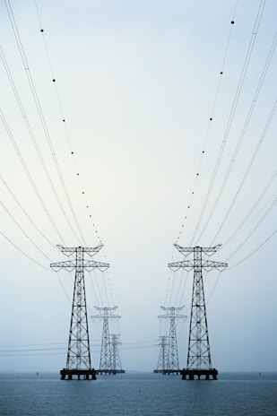 A couple of power lines sitting over a body of water