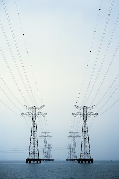 A couple of power lines sitting over a body of water