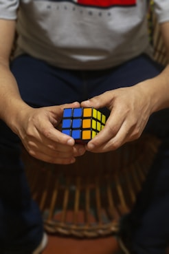 A person holding a rubik cube in their hands
