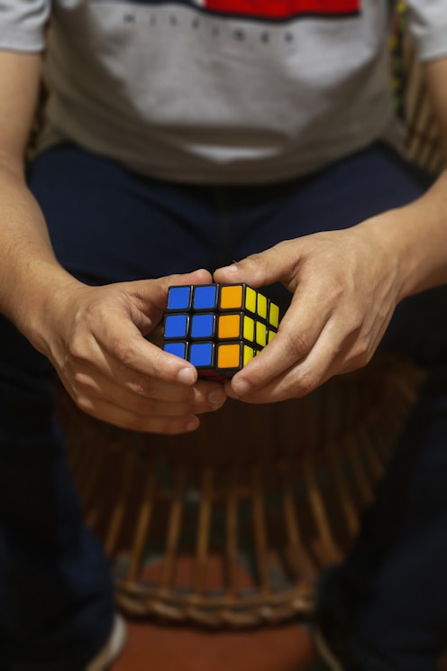 A person holding a rubik cube in their hands