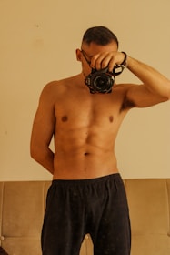 A man holding a camera up to his face