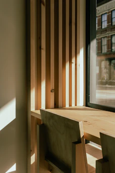 A wooden table sitting in front of a window