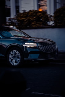 A car driving down a street at night
