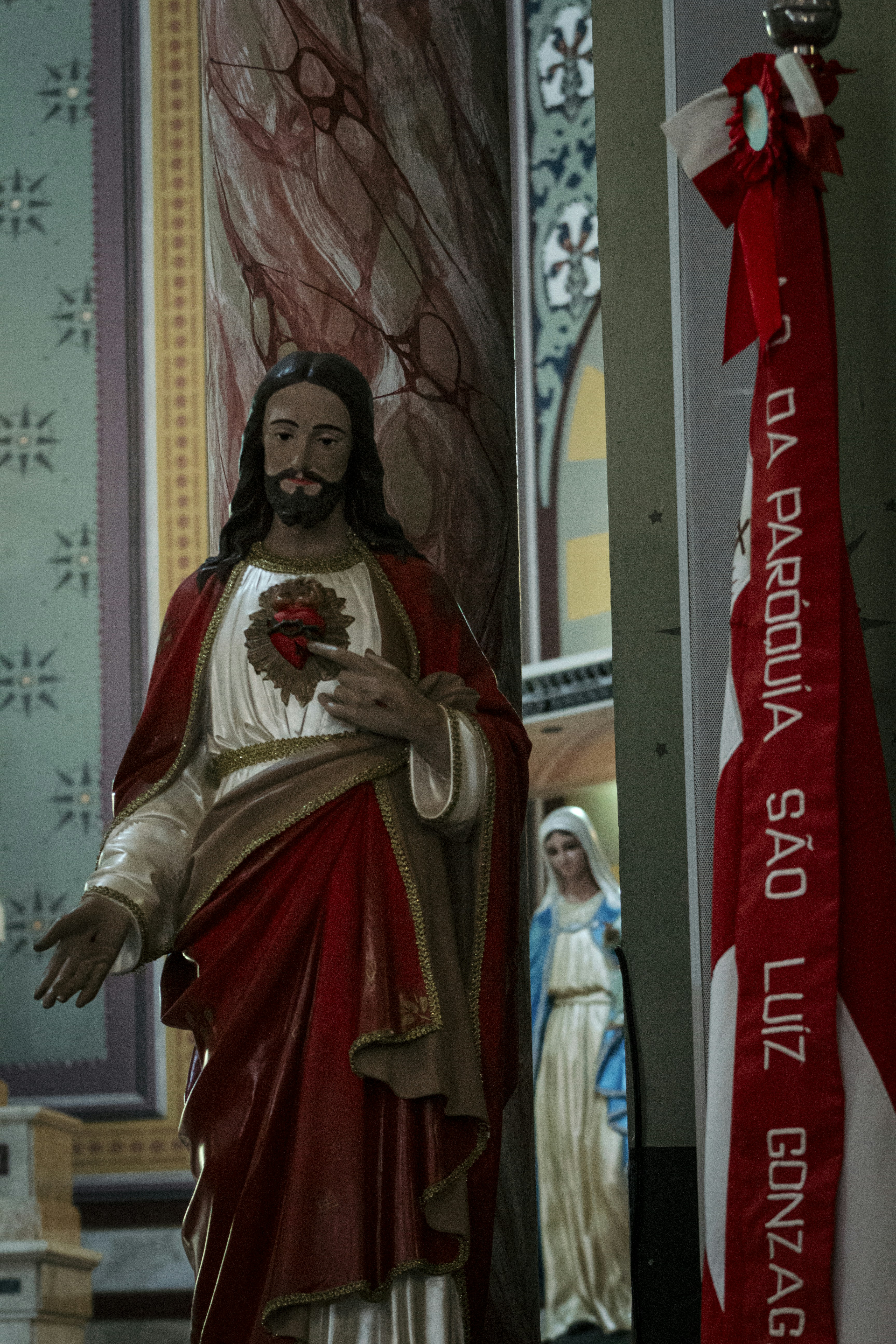 A statue of jesus holding a heart in a church