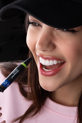 A woman with a pen in her mouth