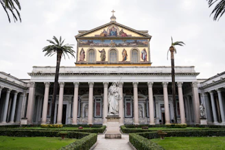A large building with a statue in front of it