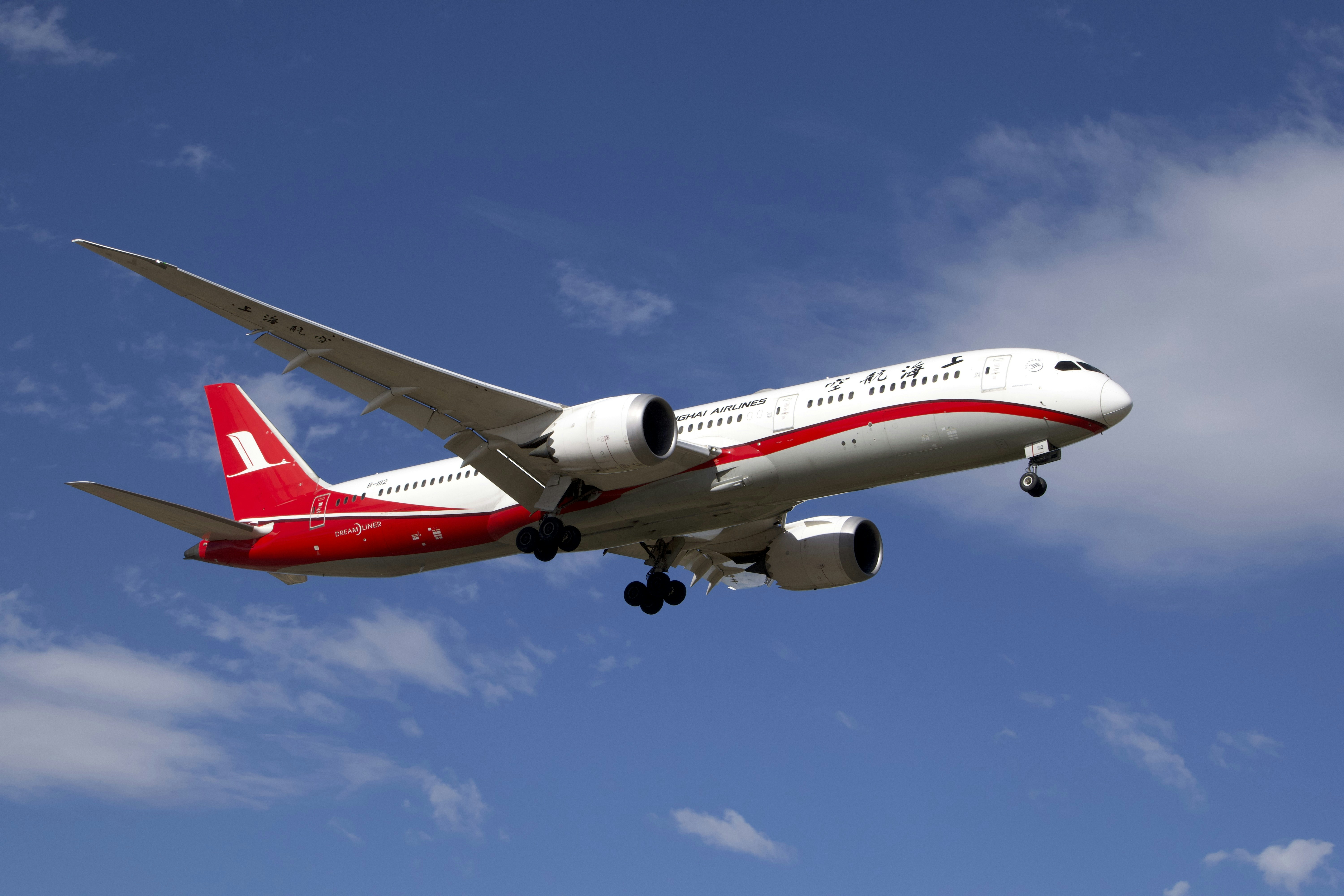 A large jetliner flying through a blue sky